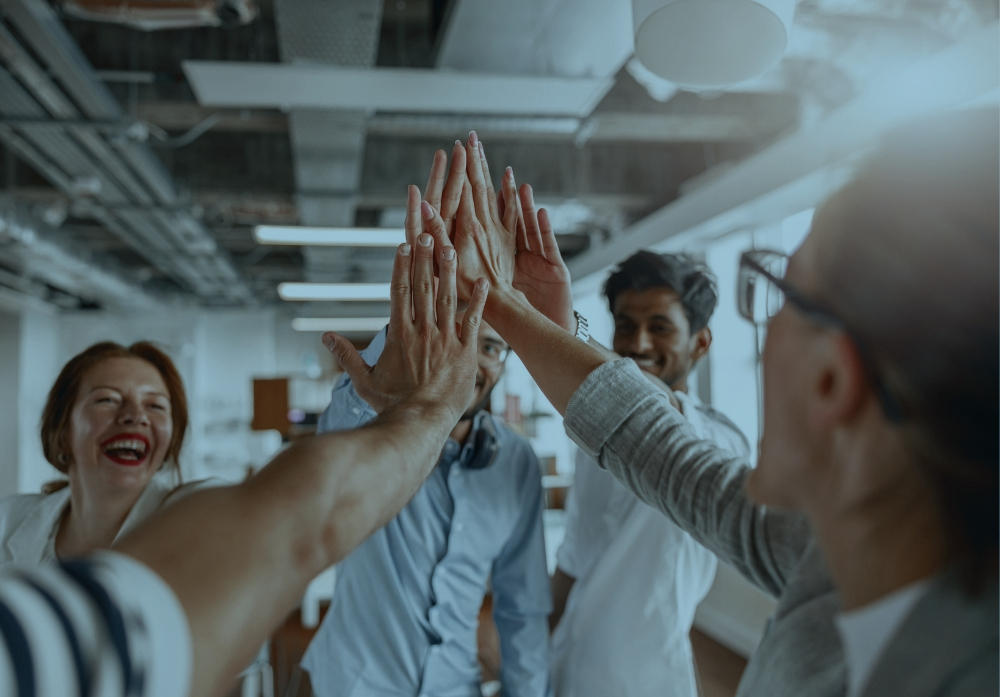 team giving high-five to each other for great collaboration